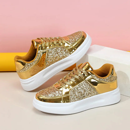 Gold sequin and metallic sneakers with thick white soles and lace-up closure.
