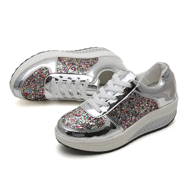 Silver platform wedge sneakers with metallic trim, white laces, and colorful sequined midsections.