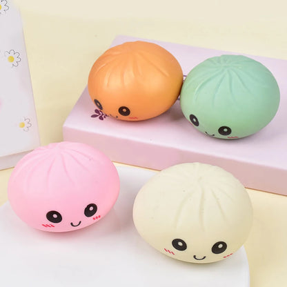 Pastel-colored silicone dumpling squishies fidget toy with smiling faces for stress relief.
