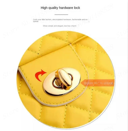 Close-up of a yellow PU leather suitcase with diamond quilting and a gold-tone metal twist-lock closure.