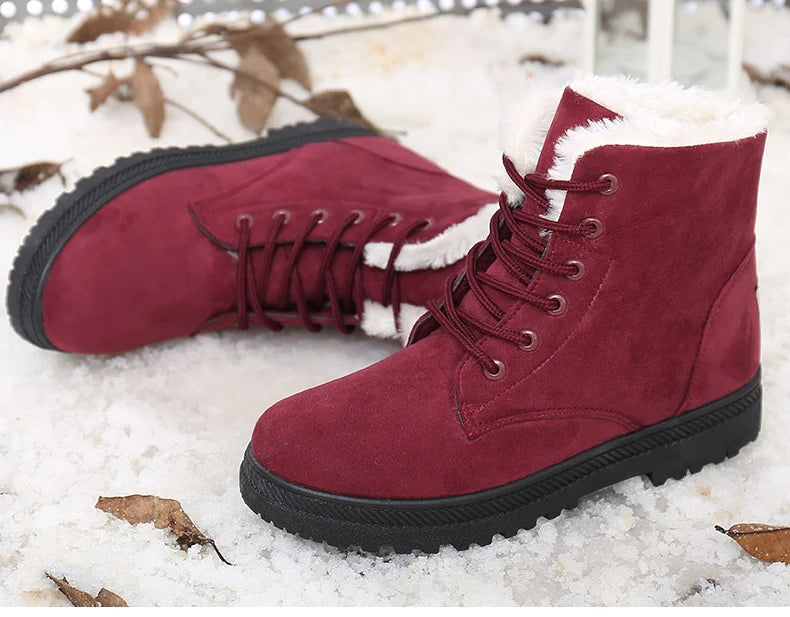 Maroon suede lace-up ankle snow boots with white faux fur lining and black flat soles.