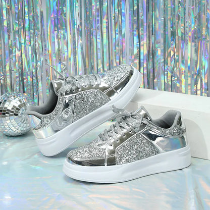 Silver sequin and metallic sneakers with thick white soles and matching laces.