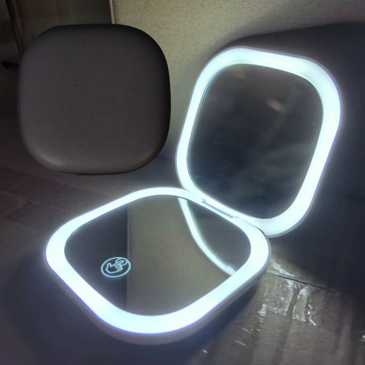 Makeup mirror with rechargeable LED lights, tabletop vanity light, and touch sensor control.