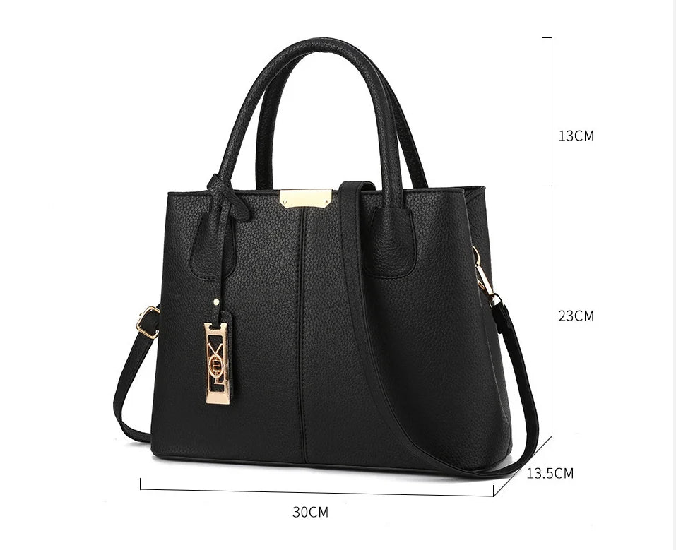 Black faux leather structured tote bag with zip closure and adjustable strap for everyday use.
