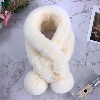 White plush faux fur cross scarf with two furry pom-pom ends.