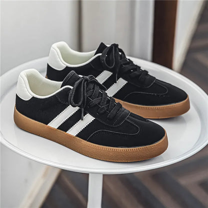 Black canvas sneakers with white stripes, laces, and gum soles. Breathable casual training shoe for daily exercise.
