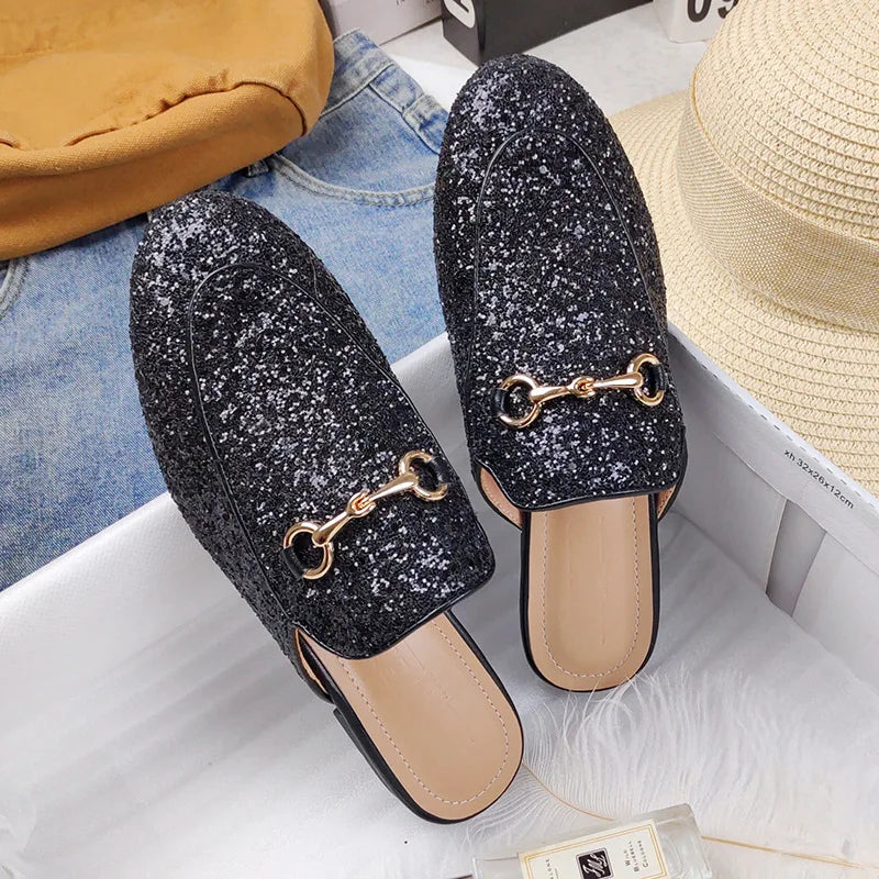 Black glitter slip-on shoes with gold chain detail for all day wear.