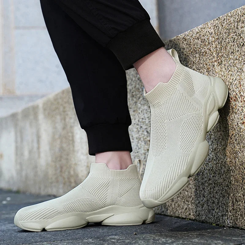 Beige slip-on knit moccasin sneaker with a breathable texture for comfortable daily wear.