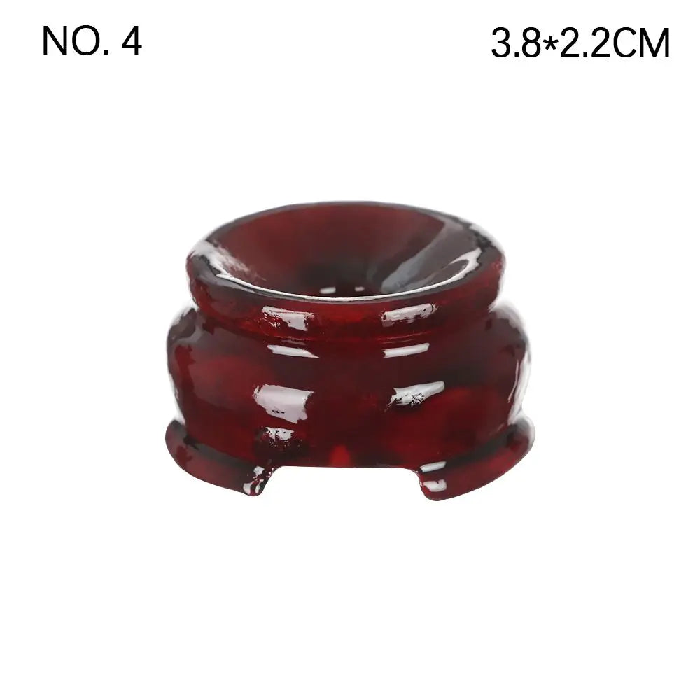 Dark reddish-brown polished wooden crystal ball stand with a rounded, footed base and a shallow top indentation.