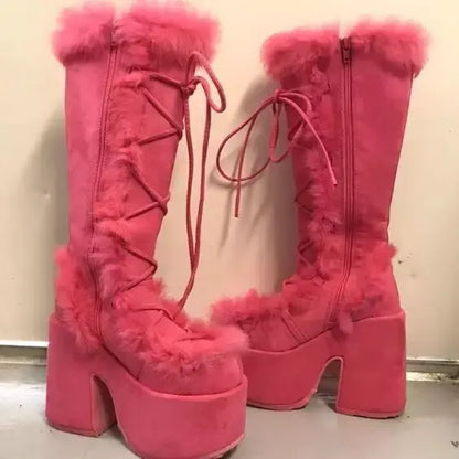 Pink platform wedge snow boots with faux fur trim, lace-up front, side zippers, and mid-calf height.