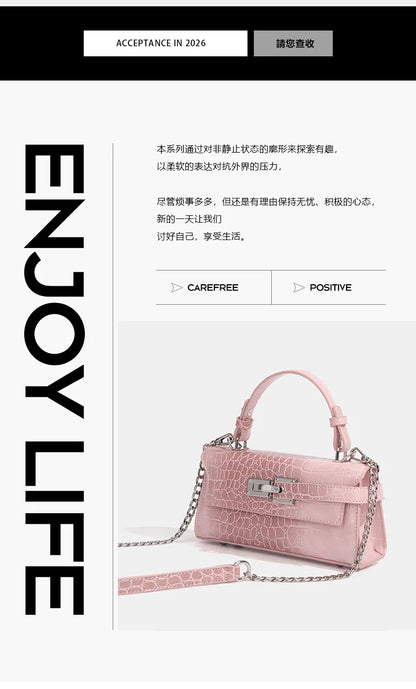 Light pink faux leather crossbody bag with structured crocodile texture, silver hardware, and chain for daily errands.