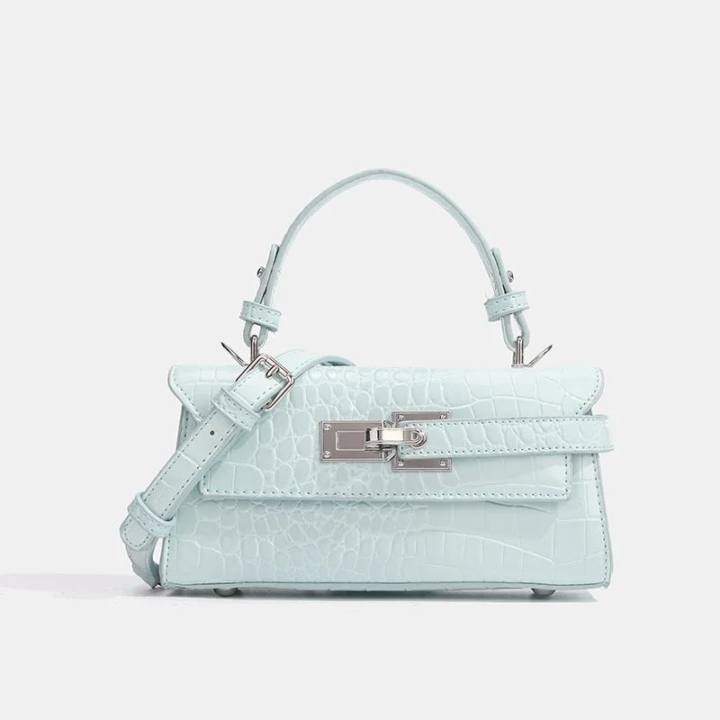 Light blue crocodile-embossed faux leather crossbody with silver hardware and adjustable strap for daily outings.