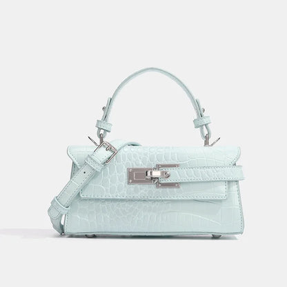 Light blue crocodile-embossed faux leather crossbody with silver hardware and adjustable strap for daily outings.