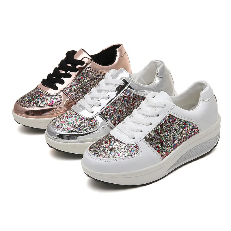Three pairs of lace-up platform wedge sneakers in rose gold, silver, and white, featuring multi-colored glitter panels.