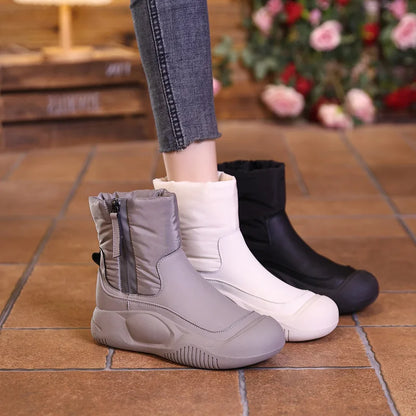 Women's short winter boots with side zippers, chunky soles, and a padded nylon shaft in grey, white, and black.