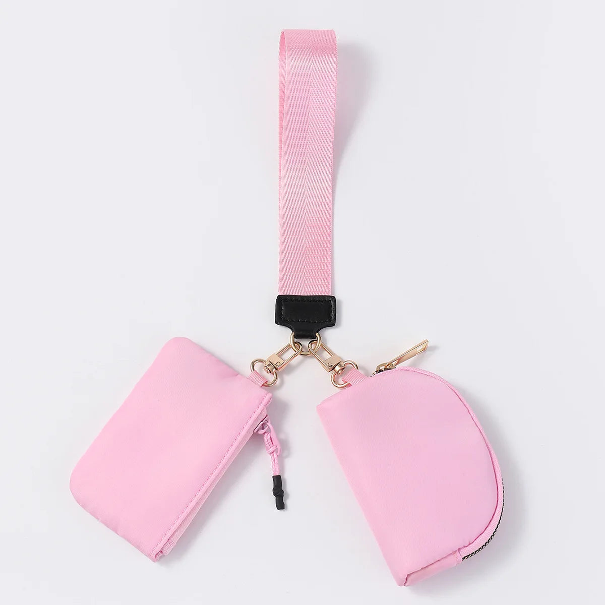 Pink nylon dual pouch with a wristlet strap and zip closure for carrying cards, coins, and keys on the go.