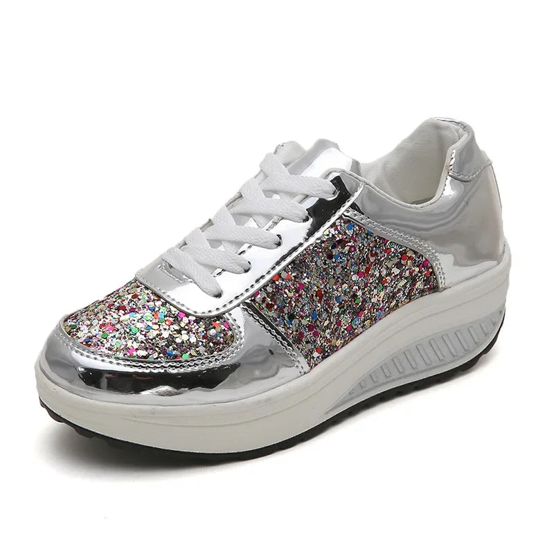 Silver lace-up platform sneaker with multicolored glitter panels and white laces and sole.