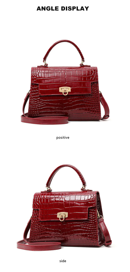 Red glossy crocodile-pattern leather handbag with a top handle, flap closure, gold hardware, and a shoulder strap.