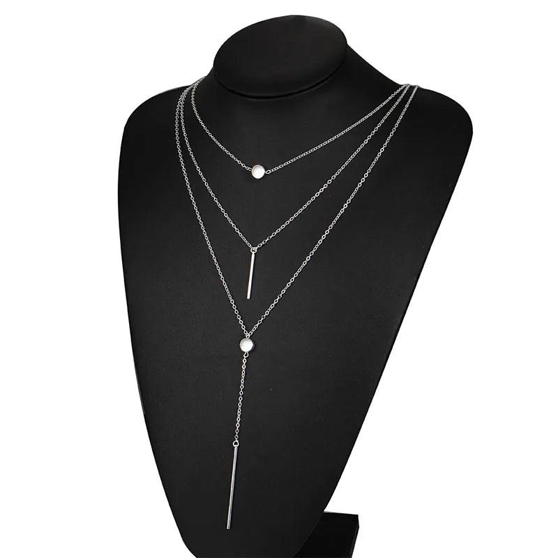 Women's gold-tone layered chain necklace with pendant detail