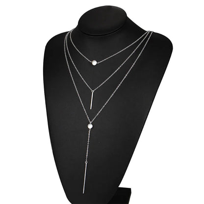 Women's gold-tone layered chain necklace with pendant detail