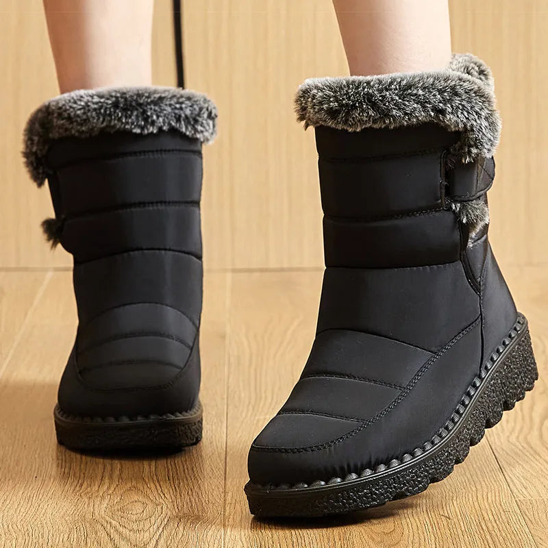Black quilted winter snow boots with dark grey faux fur trim and textured flat soles.