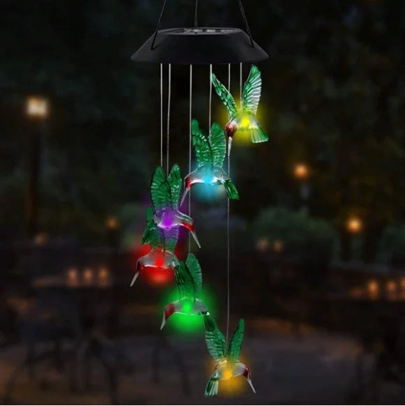Home decor solar wind chimes with illuminated hummingbird figures hanging outdoors