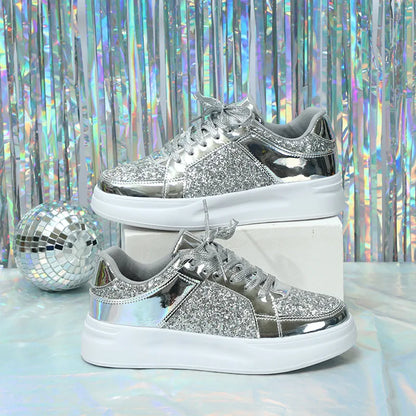 Silver glitter lace-up casual sneakers with metallic panels and thick white soles.