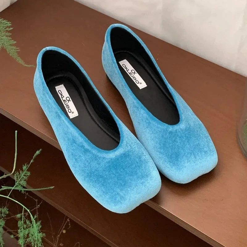 Bright blue suede square toe slip-on flats with cushioned insoles for comfortable all-day wear.