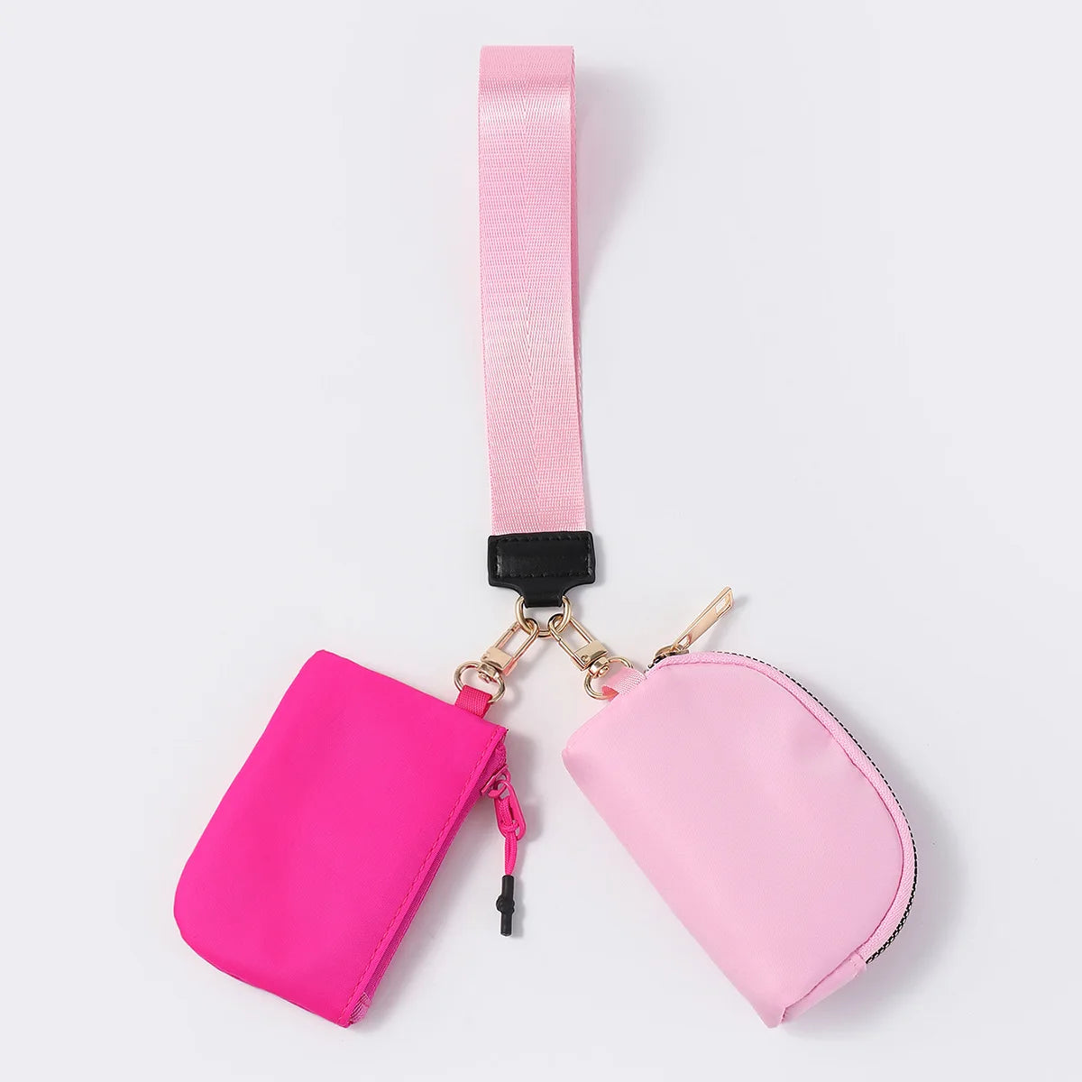 Pink dual nylon wallet with zip closure and wrist strap for organizing cards and keys.