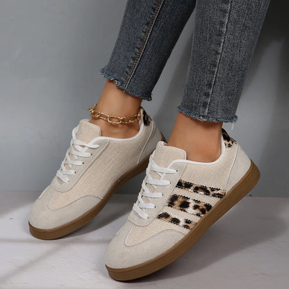 Beige canvas slip-on sneakers with leopard print side panels, brown soles, and cushioned insoles for daily walking.