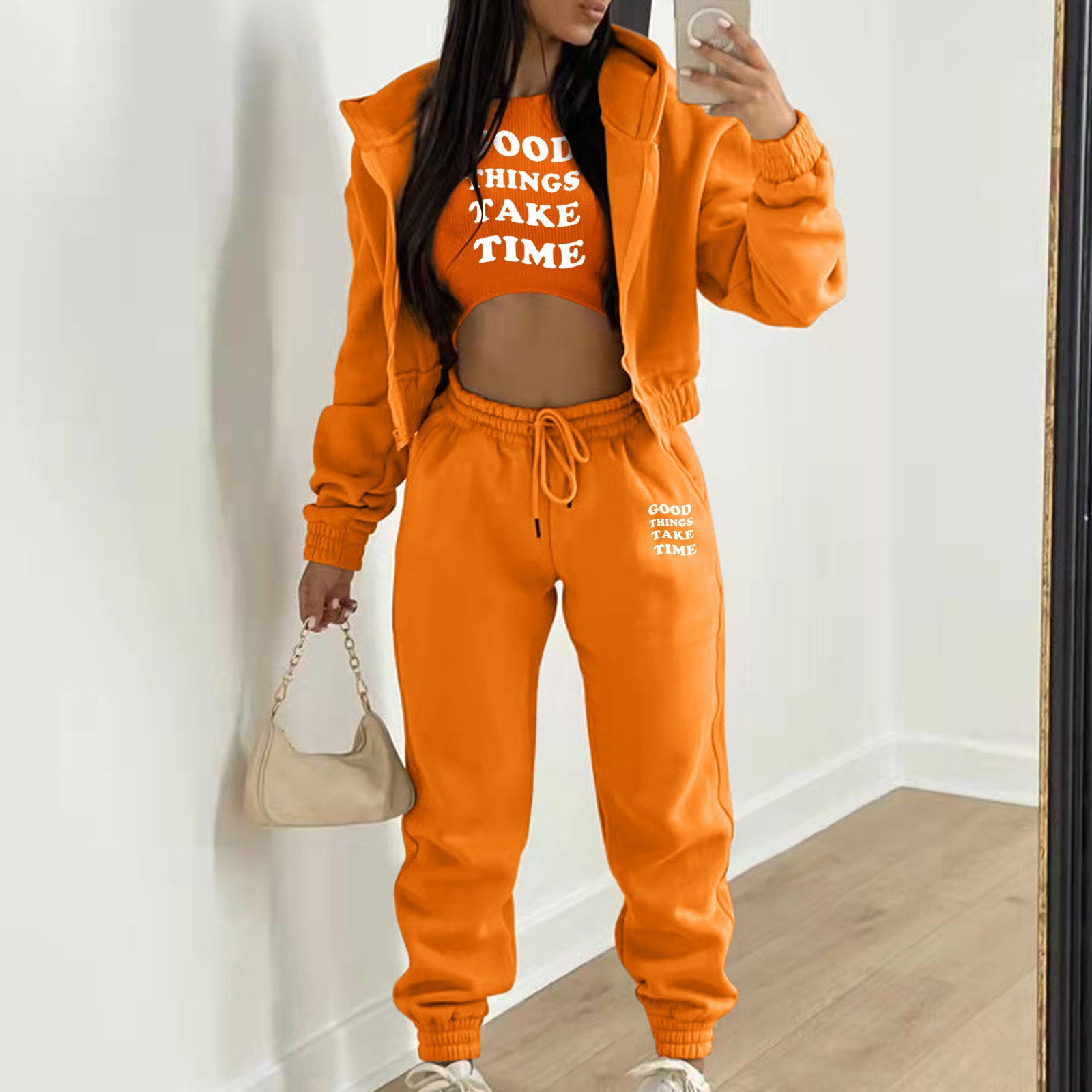 Bright orange knit sweater set with white letter print and relaxed fit for lounging.
