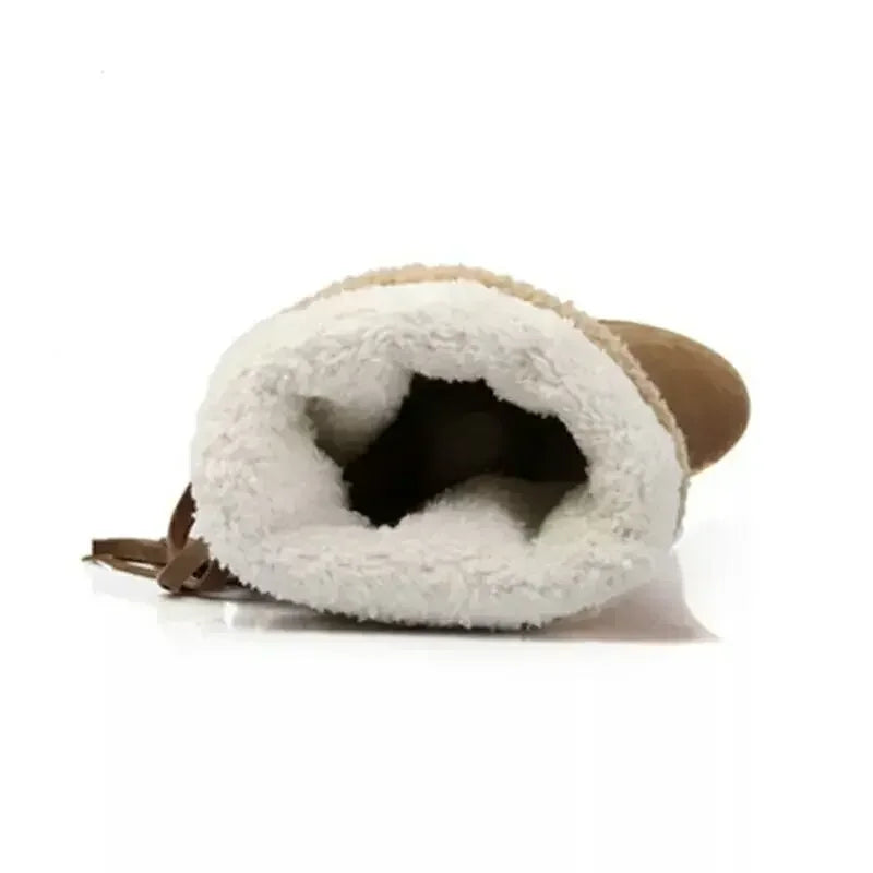 Brown suede snow boot lined with thick white faux fur, viewed from the top opening.