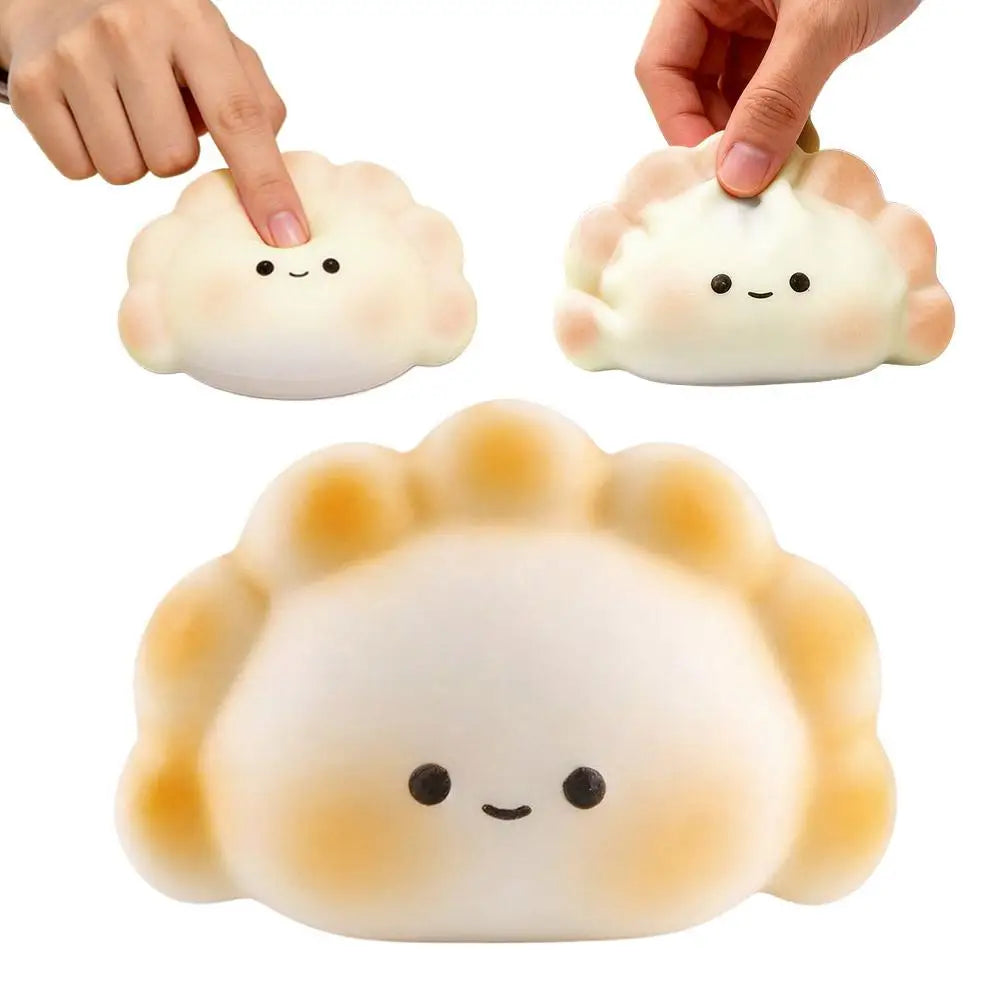 White, soft silicone dumpling squishy fidget toy with a cute face, used for portable sensory relief.