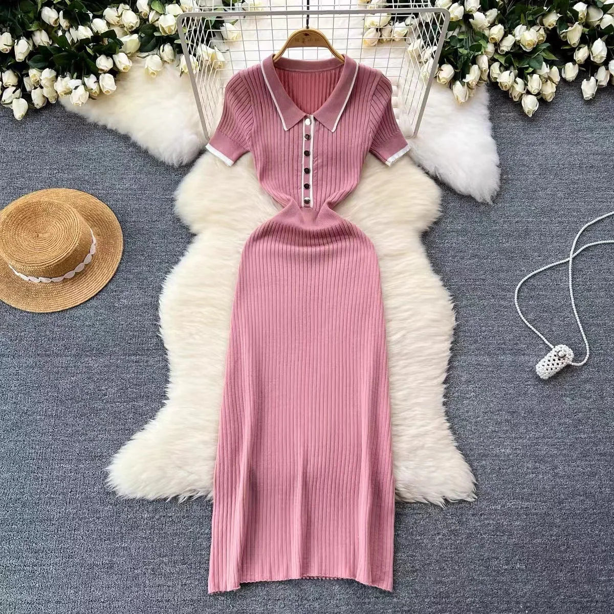 Pink ribbed knit dress with a white-trimmed polo neck and buttons, a fitted style for casual day wear.