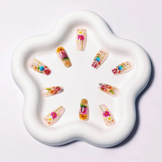 Press on nails translucent flower manicure set with artificial floral botanicals arranged on display tray