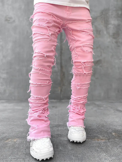 Pink distressed patchwork jeans with tassel details and a fitted design for a casual street outfit.