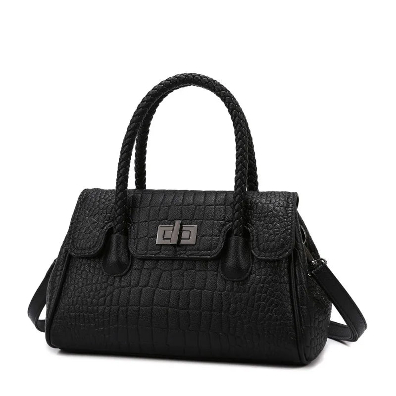 Black faux leather crossbody bag with braided handles, a structured shape, and a lock for everyday use.