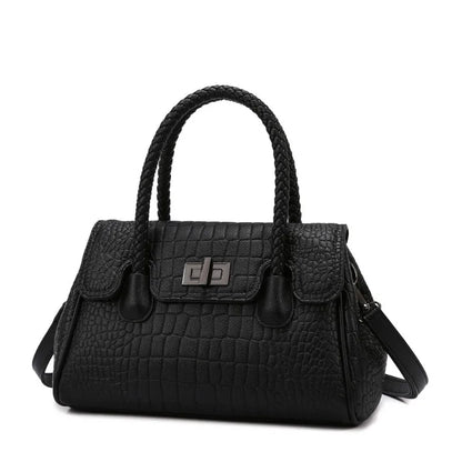 Black faux leather crossbody bag with braided handles, a structured shape, and a lock for everyday use.