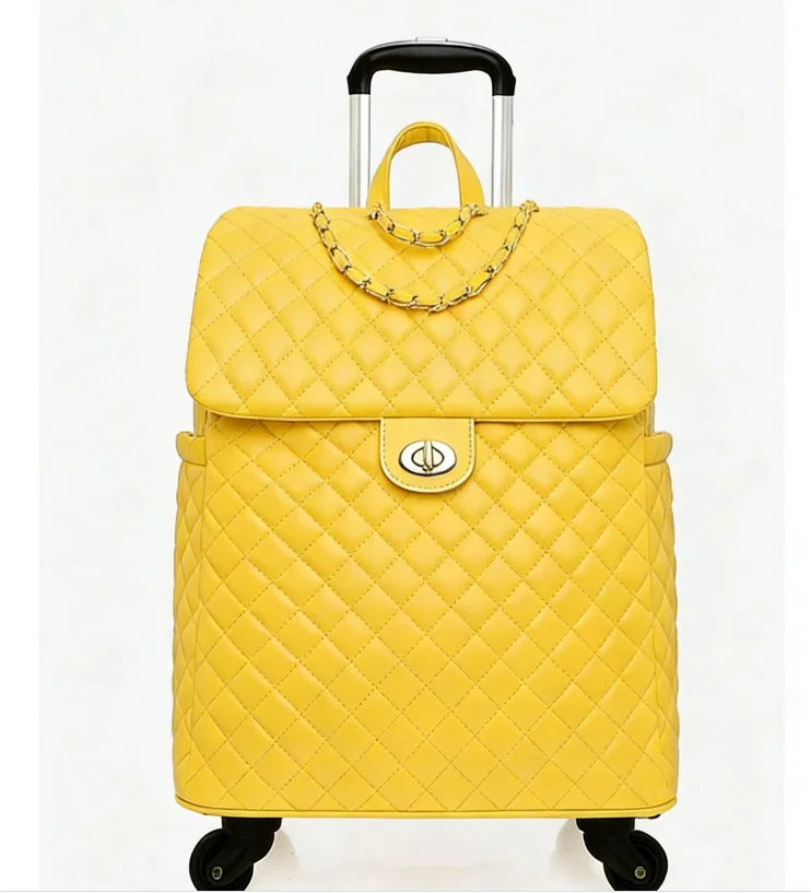 Yellow quilted faux leather rolling travel bag with a gold chain strap, twist-lock closure, and telescoping handle.