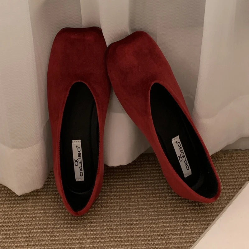 Deep red suede slip-on flats with a square toe and cushioned insoles for daily wear.