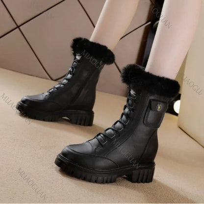 Black leather snow boots with lace-up fronts, faux fur trim, chunky lug soles, and small side pockets.