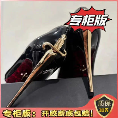 Black patent PU pointed toe stiletto pumps featuring a gold sword-shaped heel for evening wear.