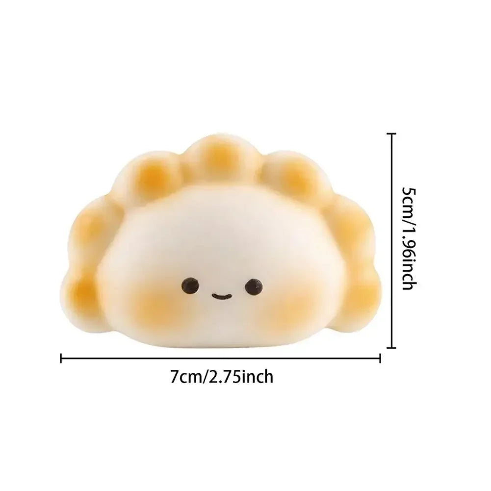 White and tan dumpling-shaped silicone fidget toy, a portable squeeze toy for stress relief.