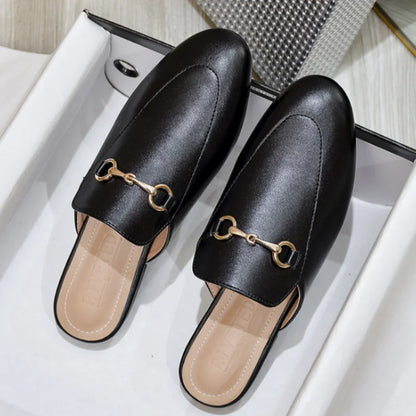 Black leather slip-on mules with a gold metal chain detail, ideal for casual outdoor wear.