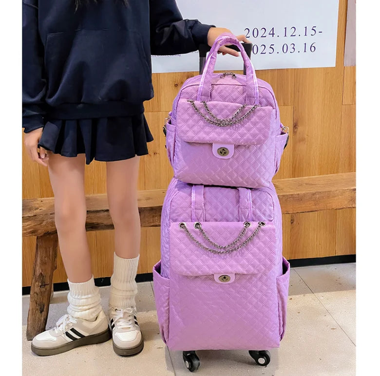 Light purple quilted rolling backpack set with chain accent, top handles, and front flap pocket.