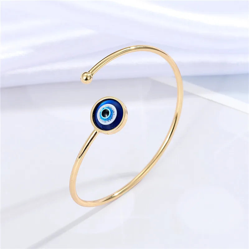 Adjustable cuff bracelet with a geometric evil eye motif