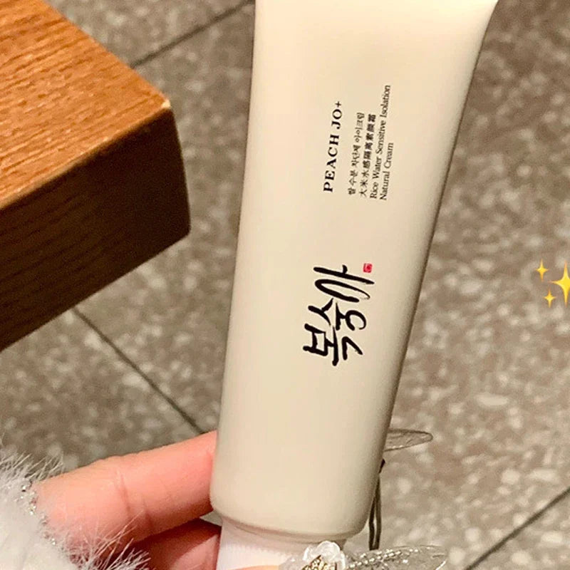 Beige, soft plastic squeeze tube of SPF50+ Rice Extract Moisturizing Cream with black text and Korean branding.