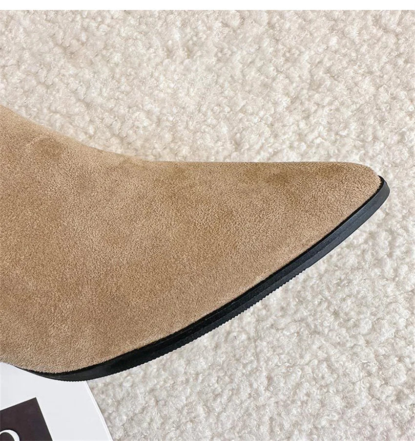 Tan suede pointed-toe boot with a black sole.