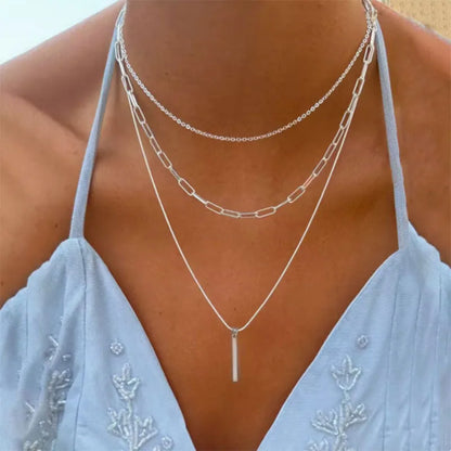 Women's gold-tone layered chain necklace with pendant detail