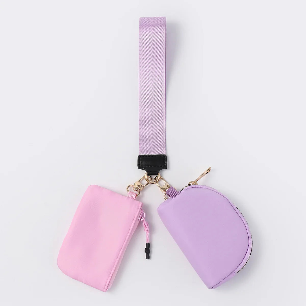 Light purple and pink nylon wristlet wallet with zip closure pouches for everyday carrying of cards, coins, and keys.